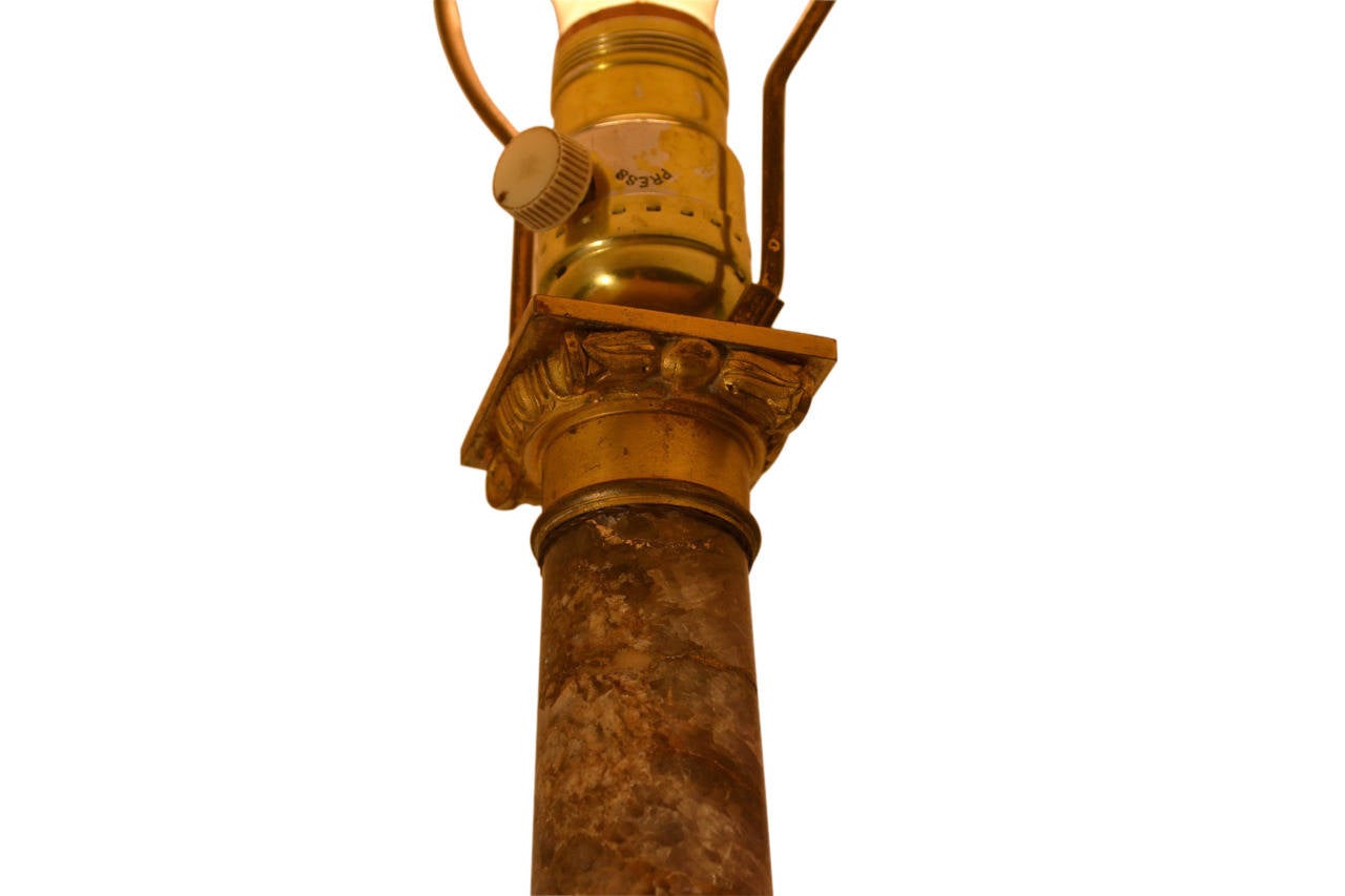 A rare example of a bluejohn stone, (Derbyshire spar), classical column now converted to a lamp, (evidence of an old repair to the column).  The column has a gilt  bronze capital and base and the whole sits on a rectangular bluejohn and black marble