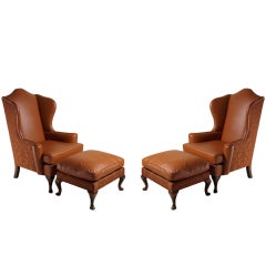 Pair of Georgian style wing chairs/ottomans in caramel leather