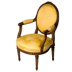 A finely carved Louis XVI style open arm chair