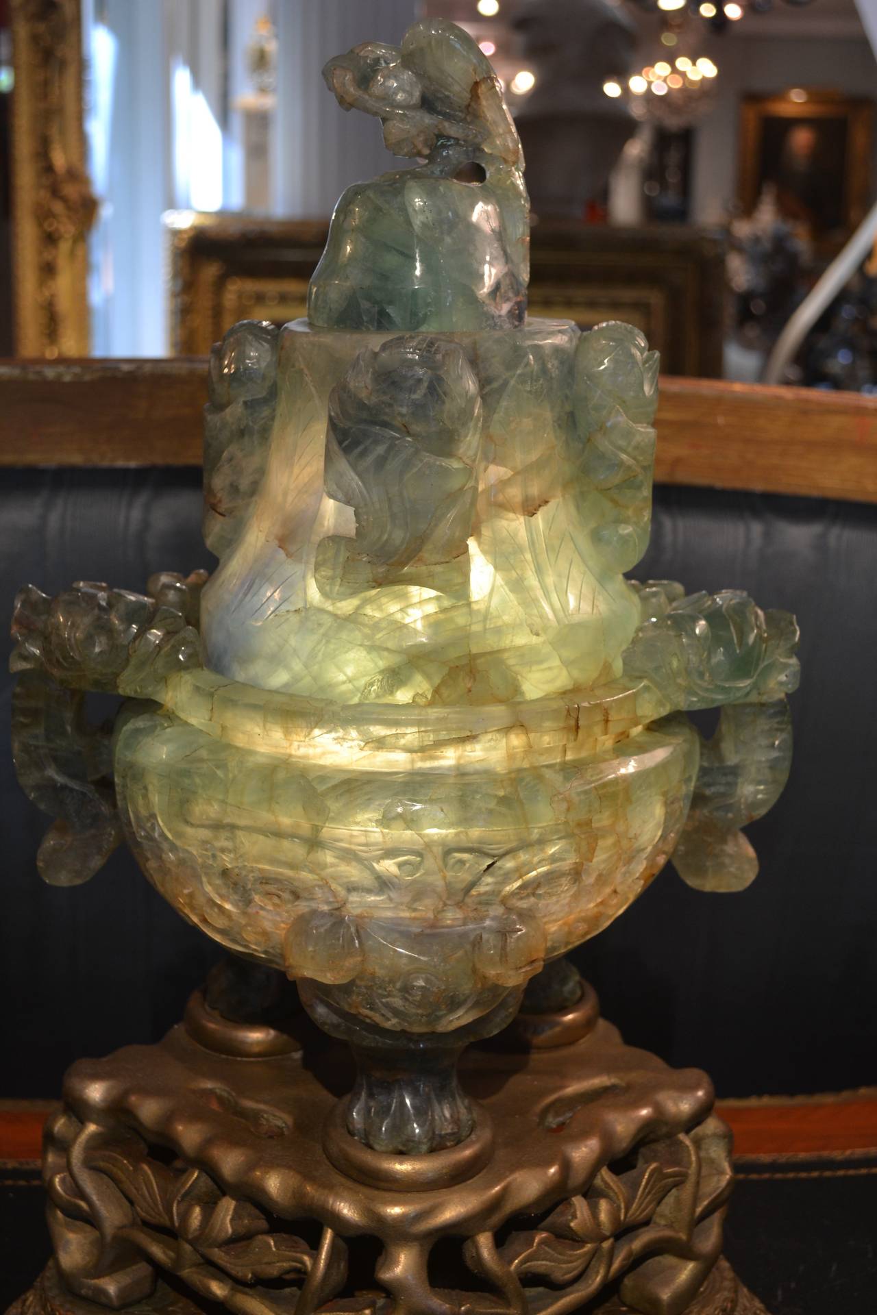 A large and rare sized 'flourite/quartz' lamp, well carved with overall Asian motives and lit from the inside; mounted on a painted rosewood and gilded metal base. The stone in these types of Chinese carved lamps is often referred to as quartz, or