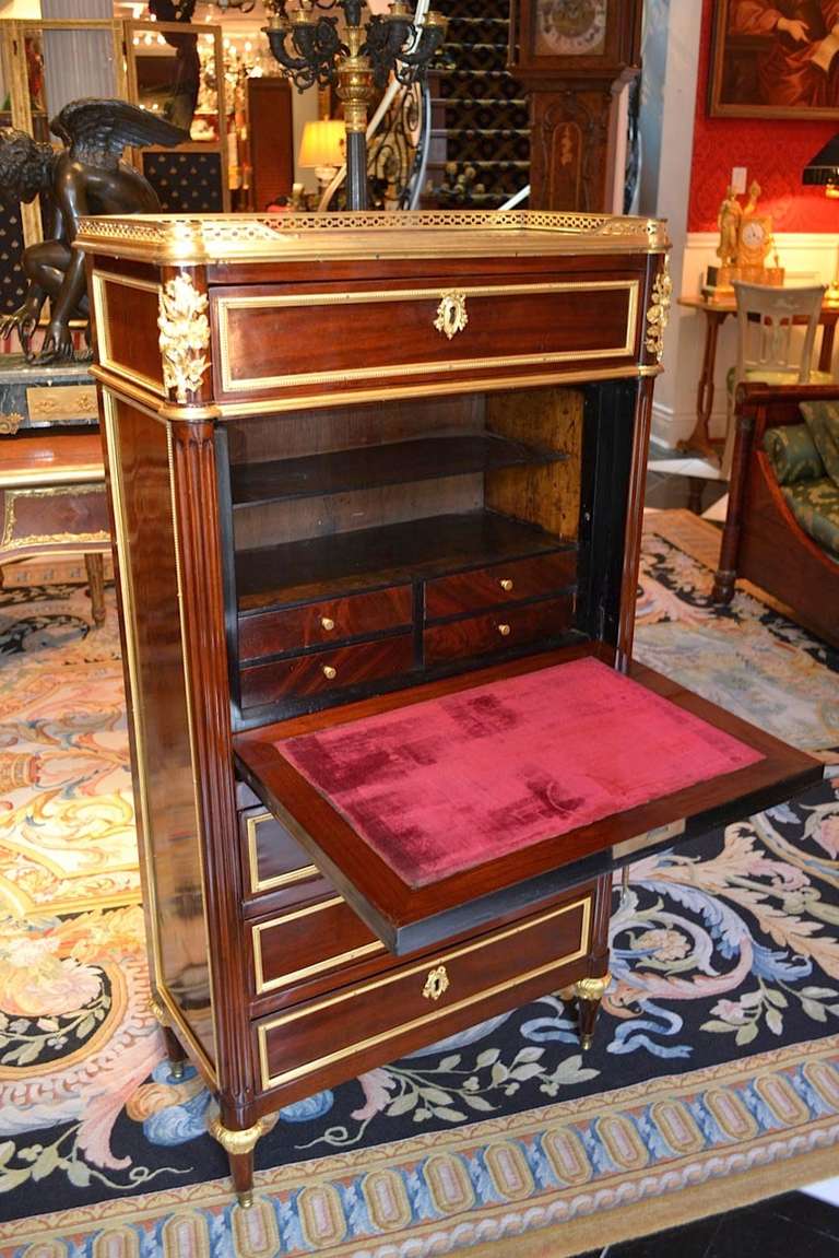 A very nice small scale French Louis XVI abbatant (drop front desk) and chest of drawers in mahogany and satinwood with gilded bronze mounts, the satinwood door front opening to reveal a fitted interior and a velvet lined writing surface, the desk
