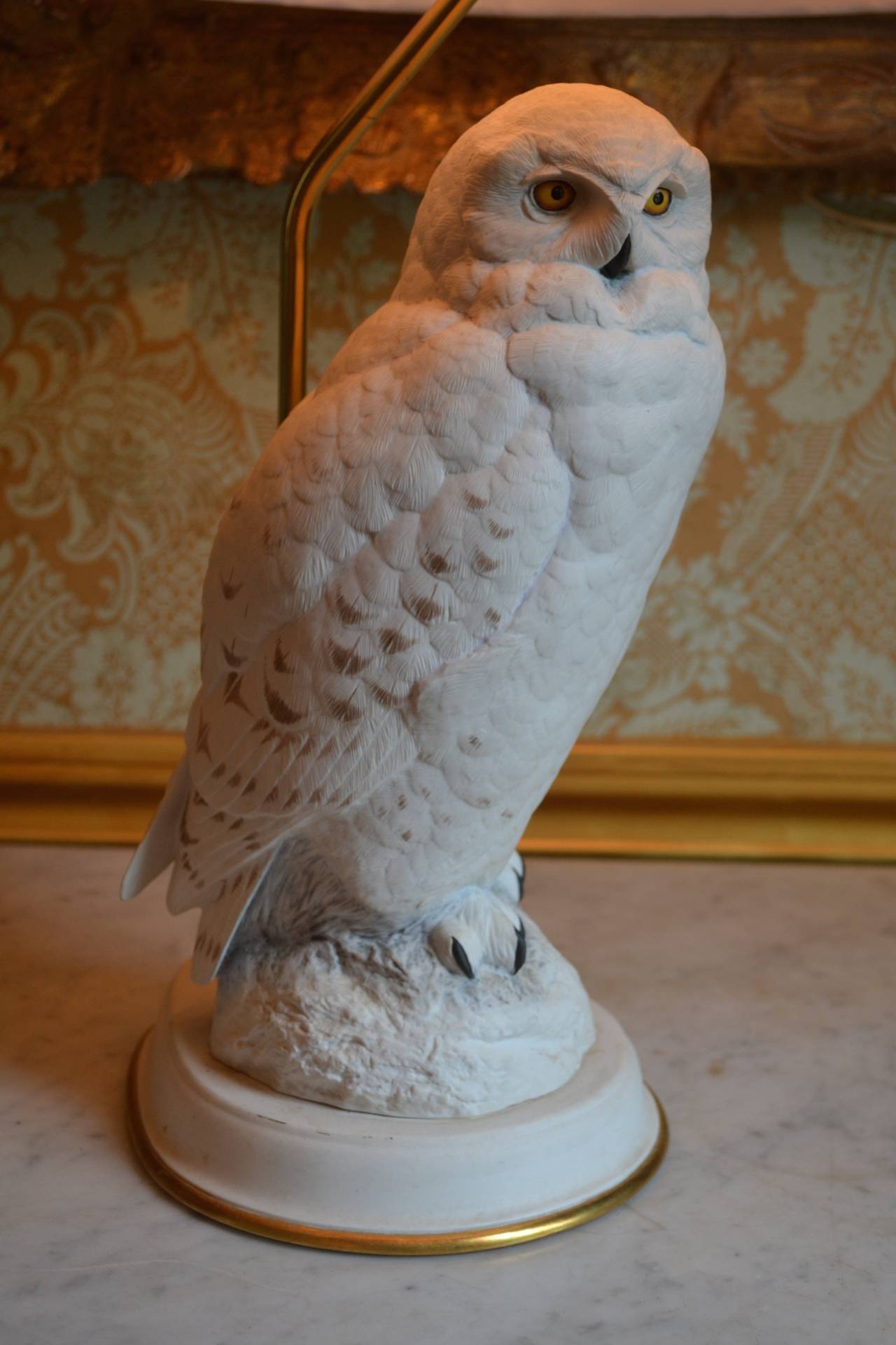 A very well modelled porcelain snowy owl which sits on a rocky outcrop, the whole now mounted as a lamp.  Note that the felt covering the bottom of the lamp has not been removed to determine whether or not the porcelain is marked.  Likely European,
