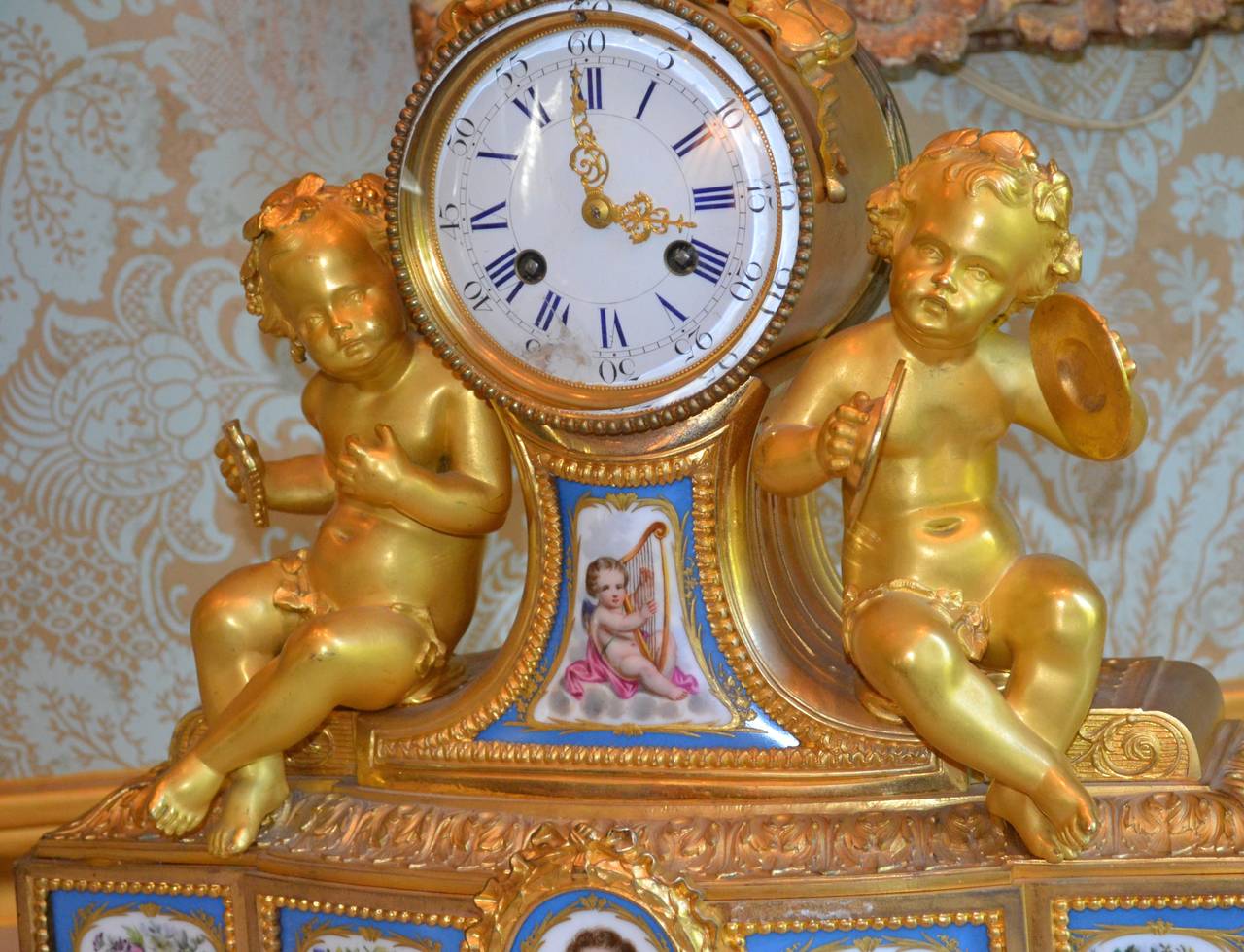 A musical themed Napoleon III gilt bronze and porcelain mantle clock