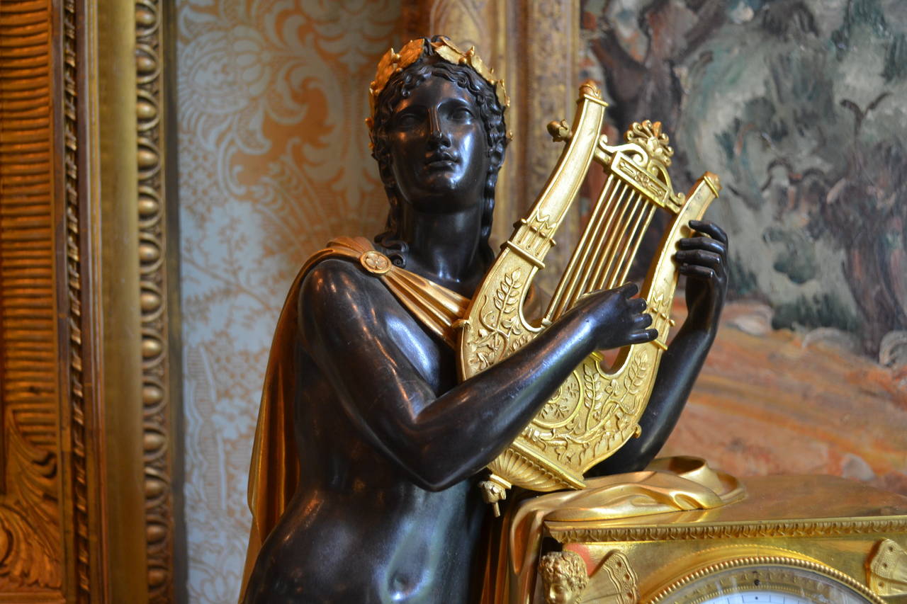 French Period Empire Clock Featuring a Standing Apollo, God of Music For Sale