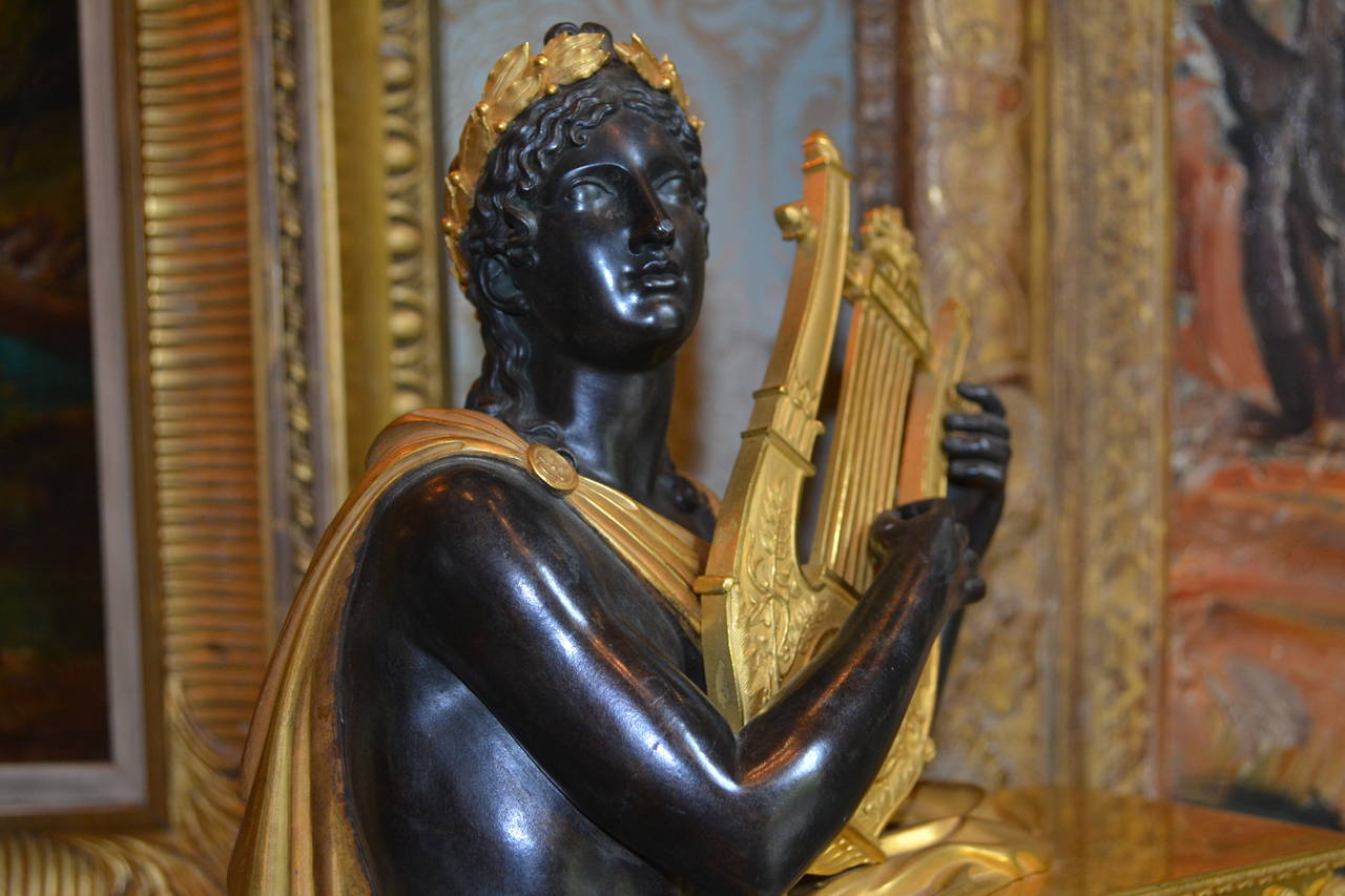 Gilt Period Empire Clock Featuring a Standing Apollo, God of Music For Sale