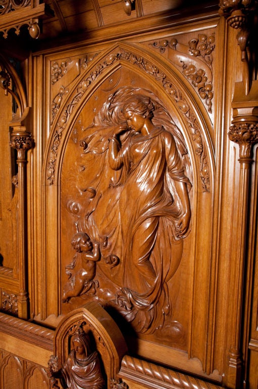 Rare and unique English Gothic Revival Queen Size Bed carved in pollard oak,  the whole emblematic of sleep, the headboard features a Madonna like figure standing on billowy clouds with a cupid tugging on her flowing robe, the other hand holding a