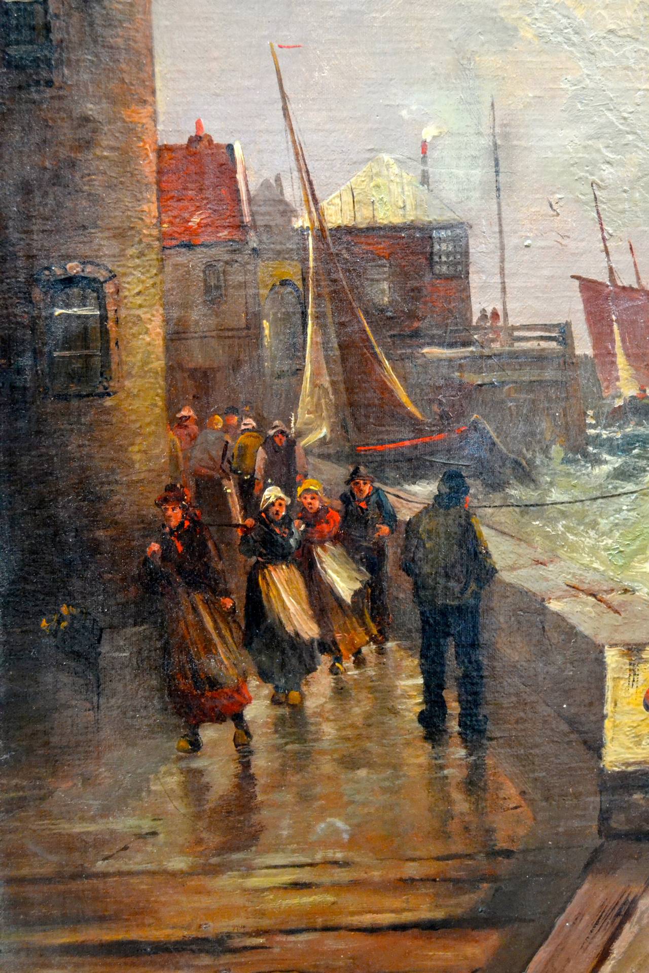 A colourful, (almost impressionist), and intense oil painting of a group of people walking along a pier in Holland?, the pier being pounded by a heavy surf, sail boats in the near and far distance also experiencing heavy seas.  The painting signed