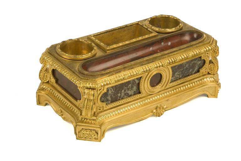 A very fine quality late 19th Century French inkwell in the Louis XVI style cast in gilt bronze having red griotte and sea green marble inserts to the top and sides.