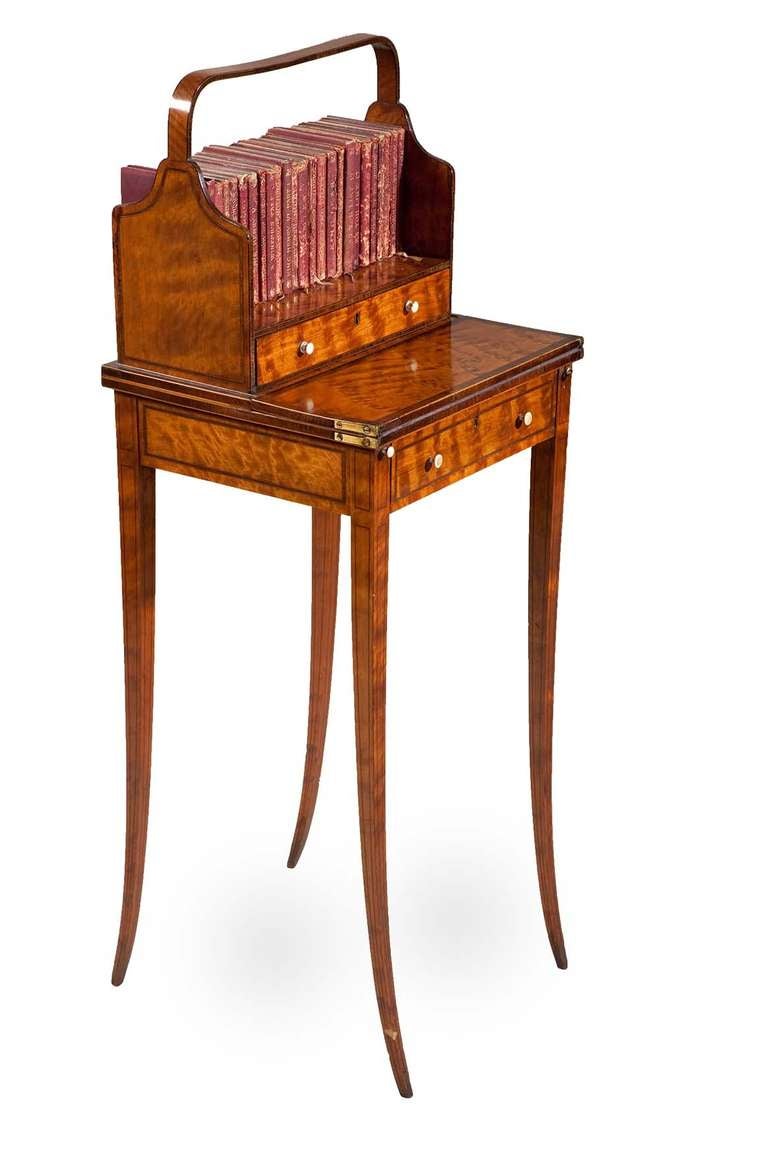 An elegant bonheur du jour (cheveret table) of the highest quality, in golden harewood banded with tulipwood and boxwood. The book tray with drawers under is detachable; In perfect untouched condition.