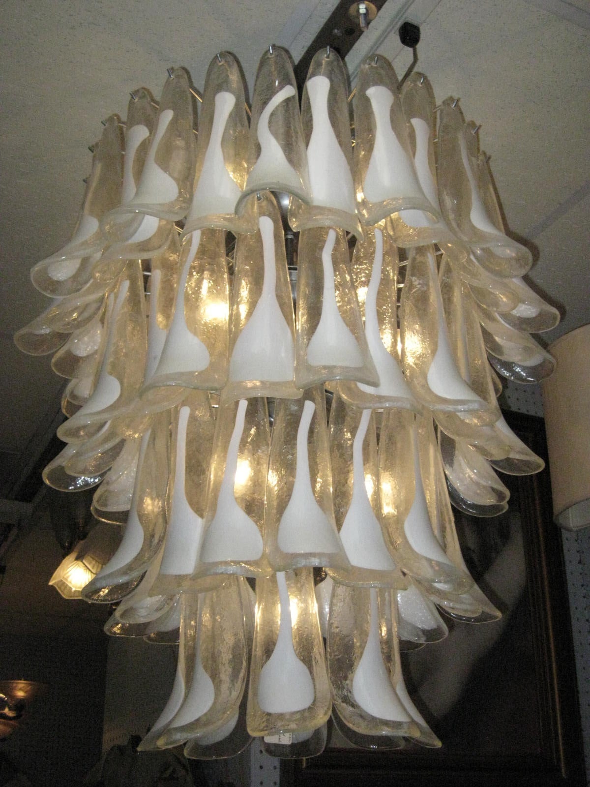 Large Italian Murano chandelier handblown with cascading tiers of calla lily shaped flowers. Each glass petal decorated with a hand-painted enameled splash of white over clear glass. The white lily symbolizing magnificent beauty and purity. 
Can be