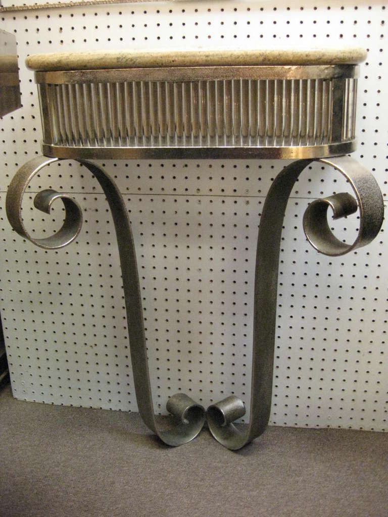 Fine French modernist console in for forge iron, glass and marble. Curved legs ending and beginning with a bold scroll motif form a graceful overall tulip shape. The top features a thick glass rod surround that supports a neutral colored bull nose