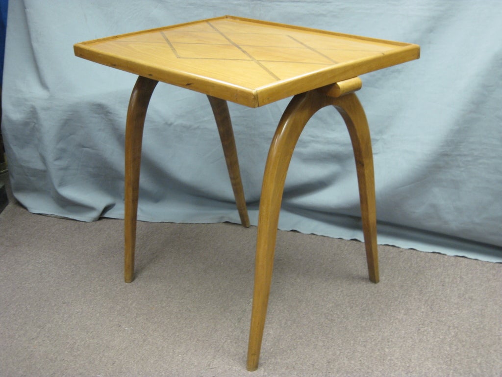A fine Belgian sycamore side table resting on sabre legs. The rectangular top inlaid with a typical diamond pattern surrounded by a molded tray like detail with handles flanking sides. 
Blond wood with inverted 