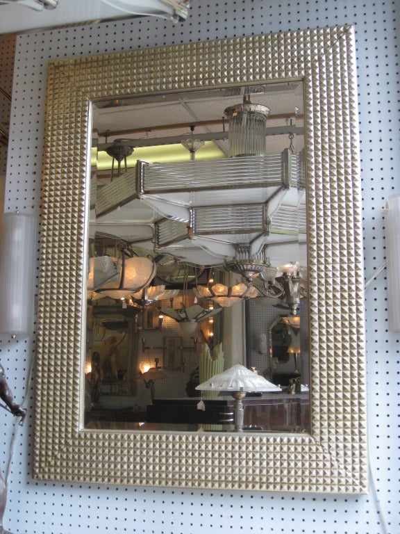 French rectangular mirror with three dimensional reticulated pattern. The gesso frame in the original white/gold finish has a beveled mirror inset. The distinctive color is a nondescript, neutral - neither silver nor gold finish that can fit well