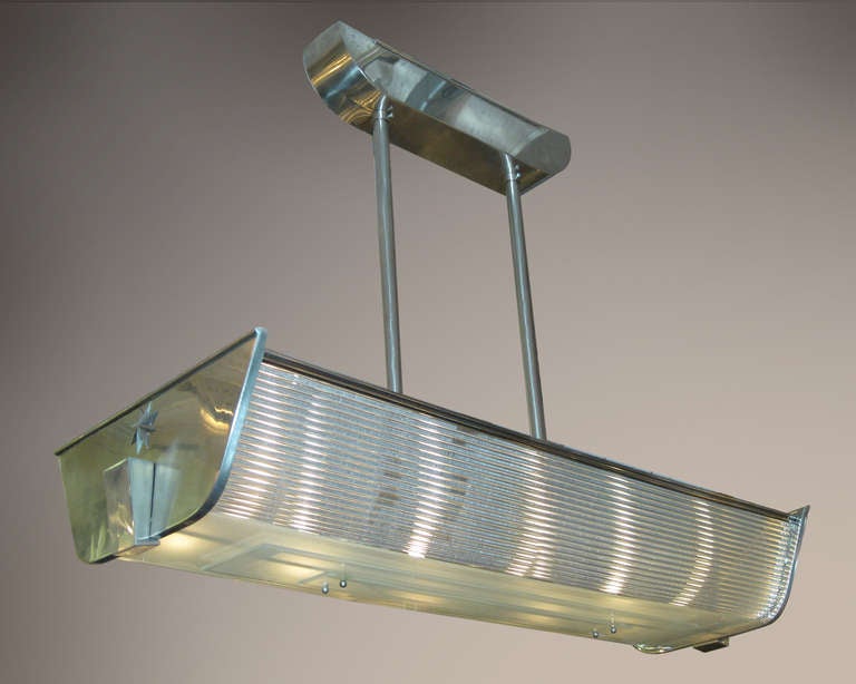 This unique rectangular shaped modernist chandelier, circa 1940, is attributed to P. Fargette. A French chandelier of billiard style and Industrial Design with an elongated demilune edge profile, stepped flat frosted bottom glass and sides formed of