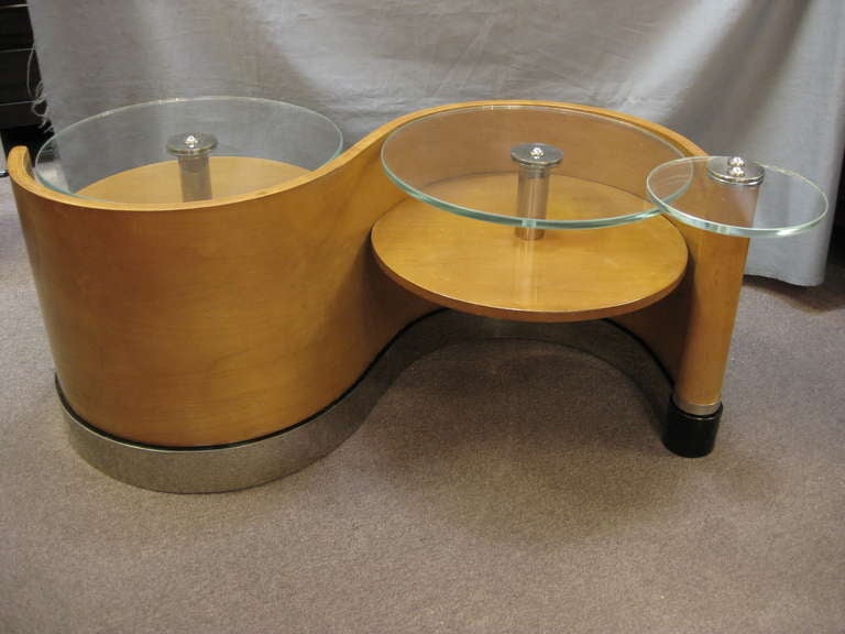 Unusual and sculptural Modernist coffee table circa 1940 attrib to Jean Royere. Organic lines create fluidity with two stationary glass tops and a third pivoting smaller glass top, suspended by center poles in nickeled bronze with matching nickeled