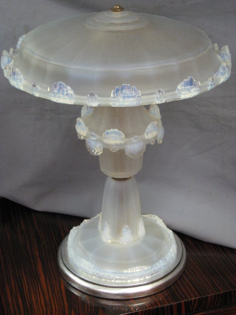 French unusual waterfall motif opalescent art glass table lamp attributed to Ezan. All glass shade, stem and base in a cascading motif reminiscent of icicle droplets and ending in silver leafed wood circular base. The opalescent glass has a