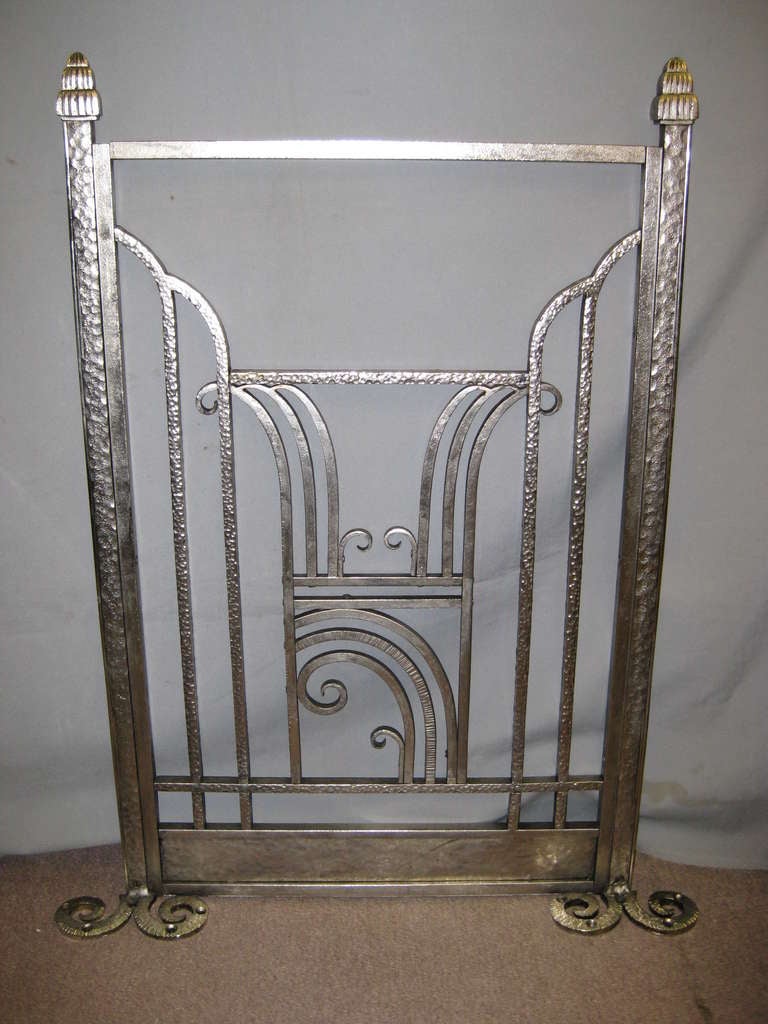 An unusual, original French Art Deco 1920s hand-forged iron fire screen. Sleek linear and scroll details characterize this decorative frieze. Some of the finest expressions were manifested in the ironwork of the era. Restored back to the original
