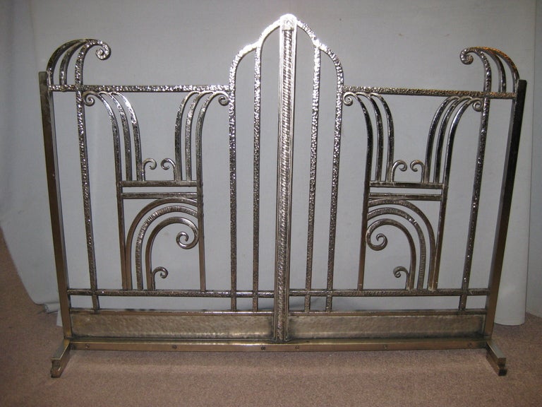 
A fine original French Art Deco hand hammered iron fire screen. Sleek linear and scroll details characterize this decorative frieze. Some of the finest expressions were manifested in the ironwork of the era. Restored back to the original hand