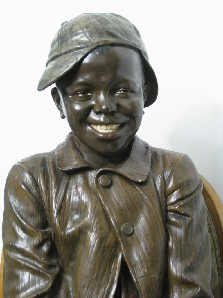 Jugendstil Lifesize Goldscheider polychrome figure of a black boy seated