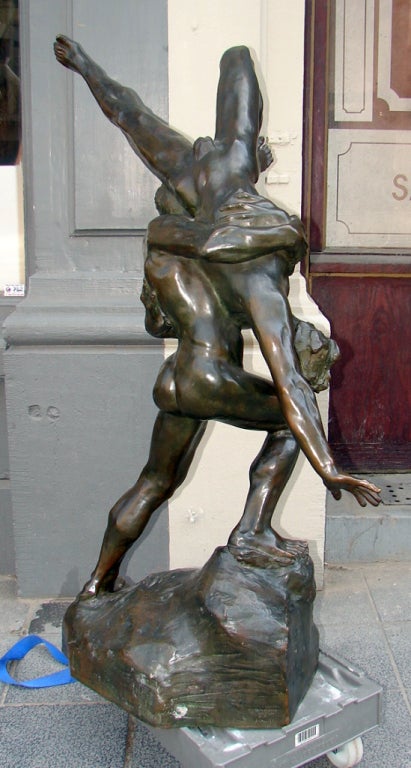 A very large and important original bronze sculpture by Jef Lambeaux of two semi nude male wrestlers in a dark greenish brown patina. It is signed by the artist, dated 1897, and has a foundry mark.  Jef Lambeaux is a Belgian sculptor born in Antwerp