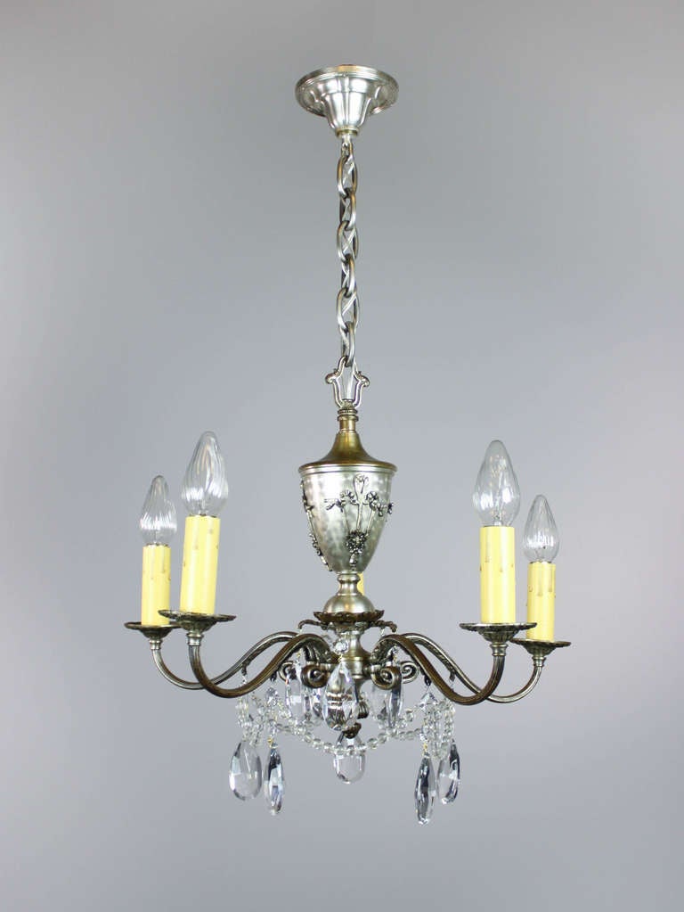 Ca. 1920 A 5-light silver plated chandelier decorated with foliate castings and crystal beaded drape. Fitted with candle tapers, re-wired and ready to mount. Measurements: 21