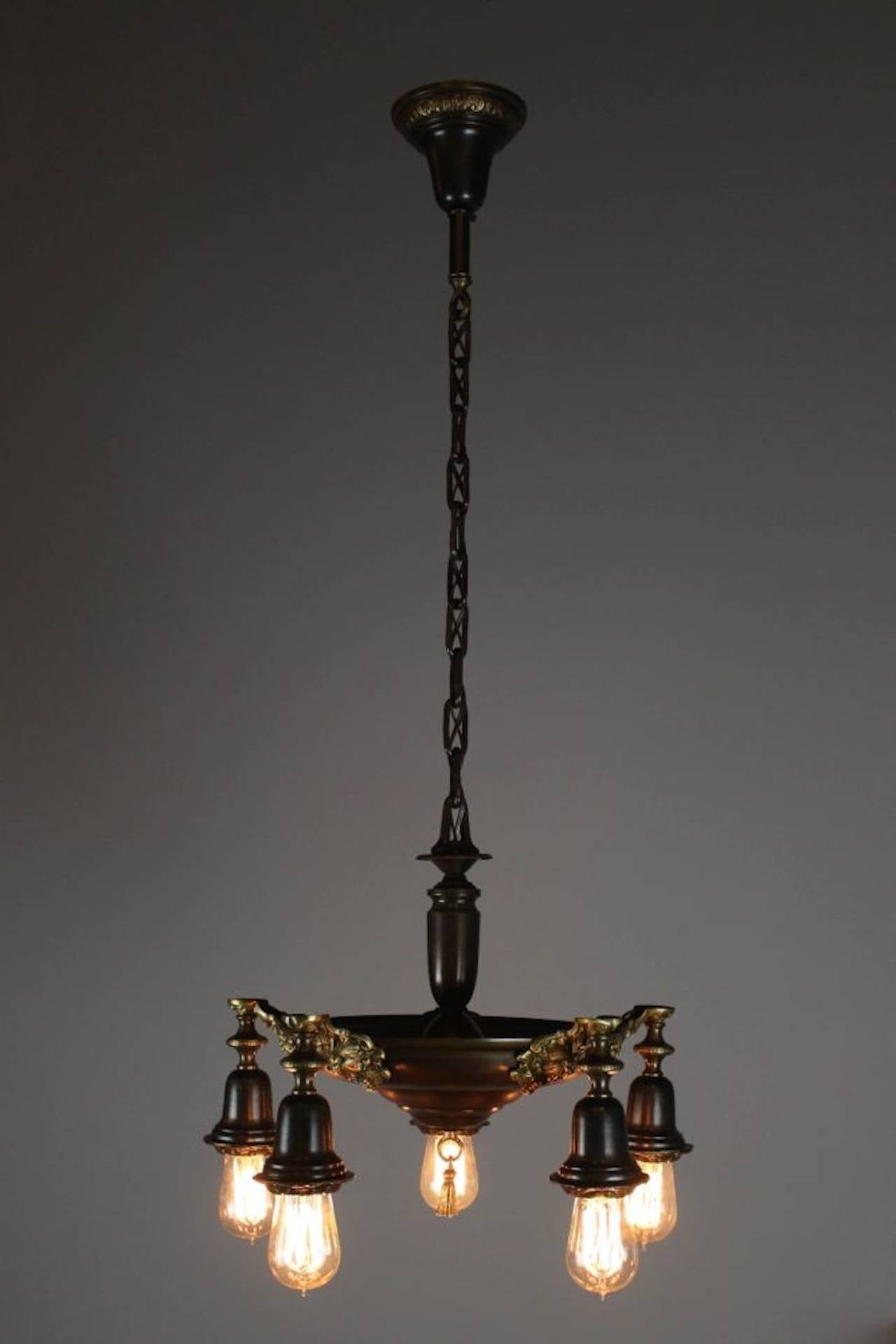 Circa 1915. A great looking pan fixture with two-tone brass. Body in dark chocolate bronze, with decorative castings in a gold-olive bronze. Fitted with Edison bulbs. Cleaned, rewired, restored, and ready to hang. 

Measurements: 42