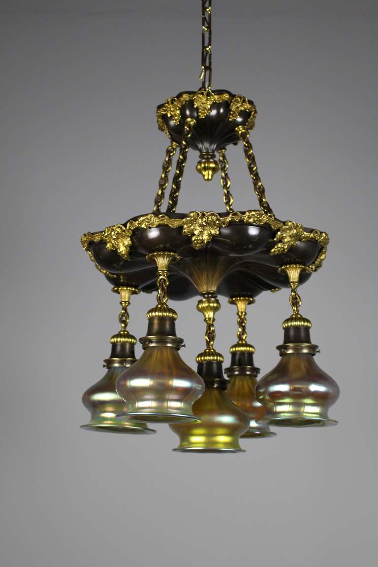 A fine quality Sheffield shower light with gilt bronze grape-motif appliqué. All original, fitted with re-cast period art glass shades, circa 1910.

An exceptional and scrumptious-looking light, Found in Kansas City, MO.
Measurements: 25″ H x