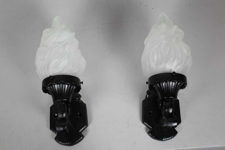 Circa 1925 pair of cast iron exterior wall sconces with frosted glass flame shade. Perfectly suited for the exterior of a home.
Measurements: 13″H x 5″W SKU: WS1046