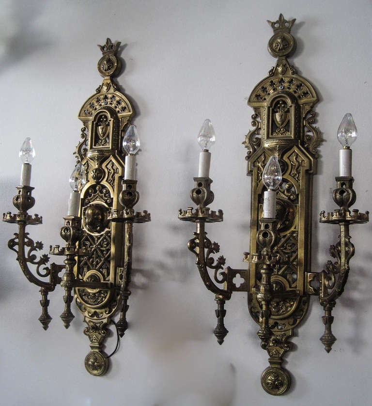 Ca. 1920 Pair of Gothic Revival cast brass sconces with literary figural motif. Original finish with patina consistent with age.
Measurements: 30