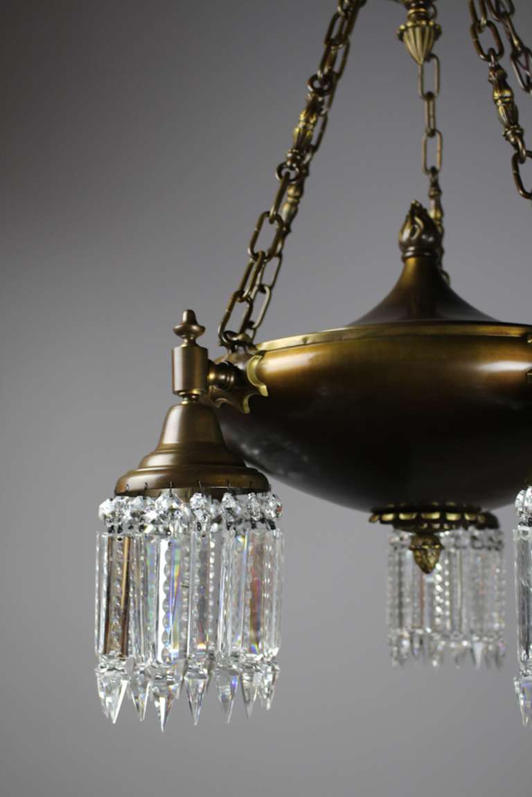This Colonial Revival fixture is attributed to Edward Miller & Co. Restored to its original finish and fitted with notched crystal, this lovely crystal chandelier is perfect for a dining room and is rewired and ready to hang, circa 1910.
      