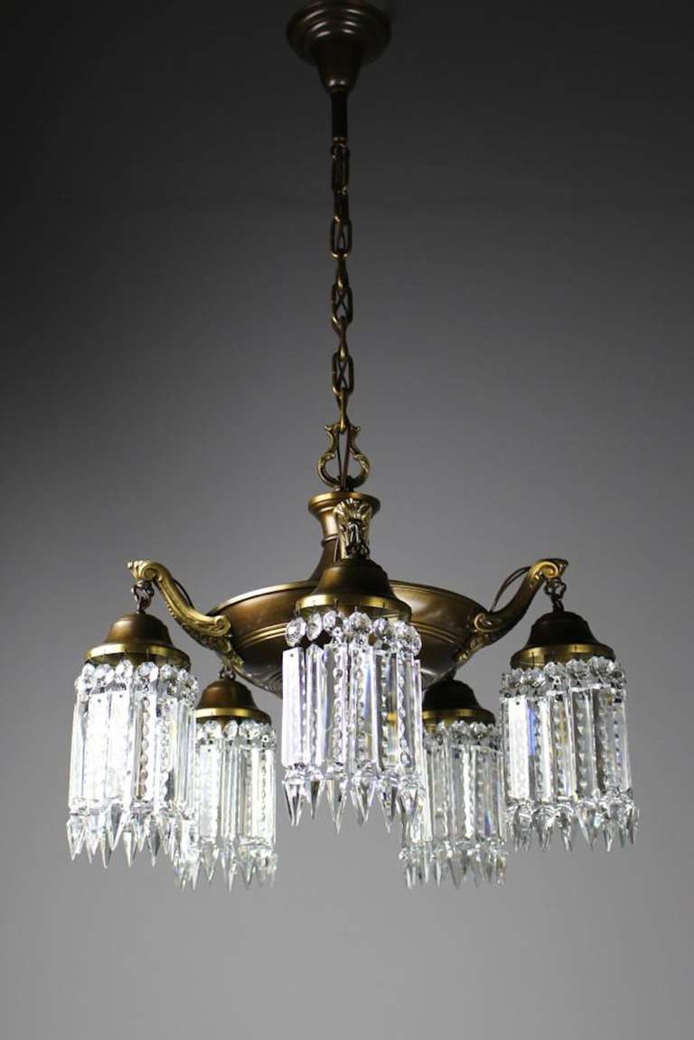 Circa 1918 This highly decorated Edwardian 5-light Chandelier is perfect for over a dining room table. Its unusually cast decorative arms are dressed in notched crystal, casting the loveliest glow. With a light like this, you are bound to see your