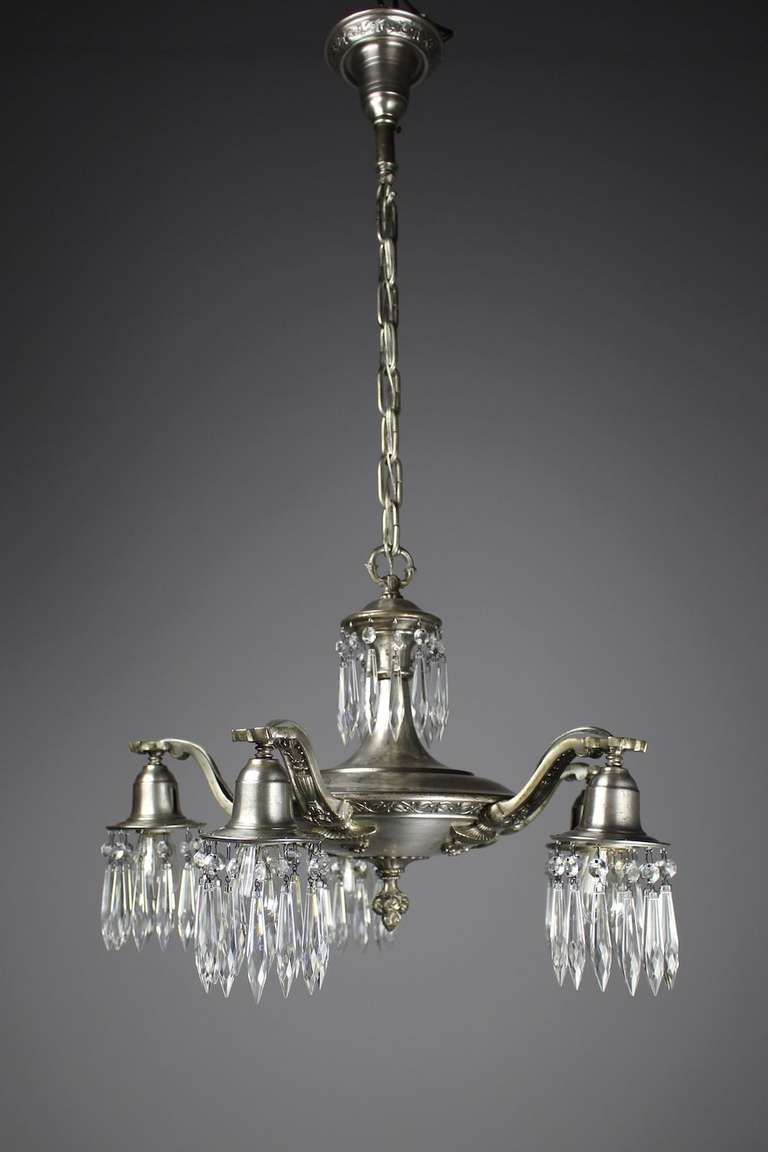 Circa 1910. A fantastic and rare pan light crystal chandelier retaining all of its original silver finish. Decorated in crystal 'swag' this light has been cleaned, rewired, and is ready to hang. Measurements: 37"Hx21"Dia. DF1152 SRP: $2750