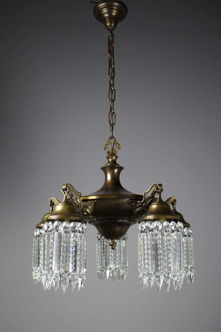 A Circa 1920 Five arm Edwardian Pan light. A hearty body finished in olive bronze and decorated in notched crystal, making a stunning addition over a dining room table or in a living room. Rewired, restored, and ready to hang. 

Measurements: