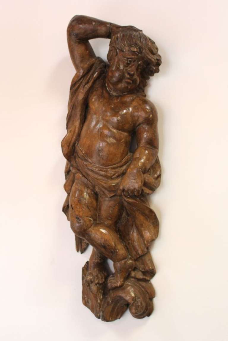 This is a lovely example of 18th century wood carving, likely Italian. A figure carved from pine, this chubby boy 'Putto', (not to be confused with a cherub) were figures used in artistic motifs of the ancient classical world of art.

Often