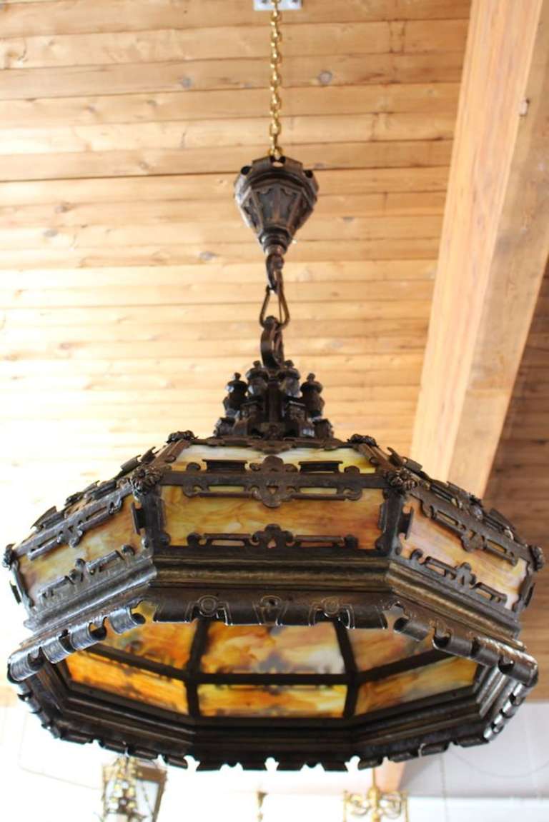 This monumental Tudor Revival piece, circa 1910, attributed to E.F. Caldwell, was completely crafted by hand, cut, and forged.

Quite possibly a custom-made light, it is of outstanding quality. All original glass. An absolutely spectacular light.