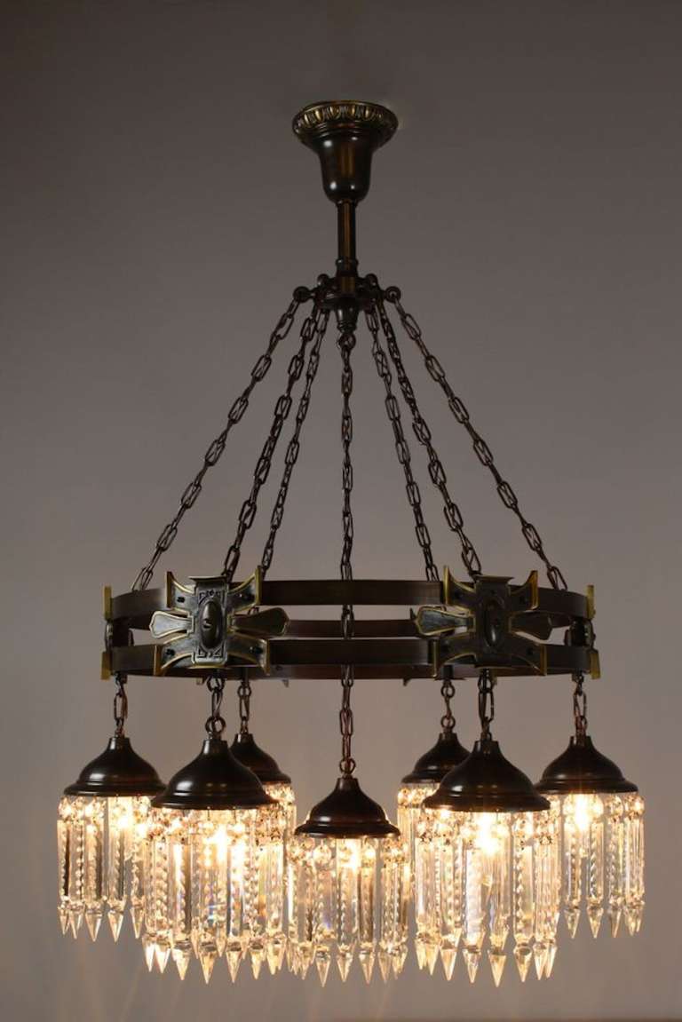 This is a great example of arts and crafts lighting, in a Gothic style, circa 1910. This seven-light crystal chandelier is finished in a dark bronze and is dressed in notched crystal, it has been cleaned, rewired, and restored.

Ready to hang,