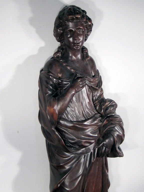 Ca. 1875 Rare carved black walnut female figure, found in an upper New York state mansion foyer. Attributed to Samuel Robb (1851-1928), a prominent wood carver and owner of a wood carving shop in New York City.
Measurements: 63