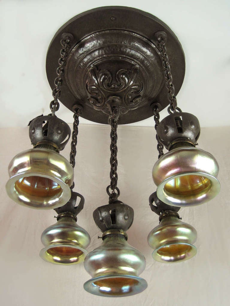 Ca. 1910 Hand-hammered iron flush mount fixture with Gothic-style decoration. Complete and original, this 5-light fixture has exceptional detail throughout. Note the correct chain and shade holders, crowned with matched iron fittings. Re-cast art