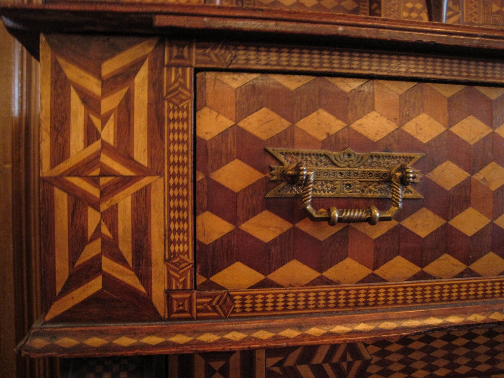 Ca. 19th Century A true masterpiece in wood inlay. American folk marquetry sideboard features two different shades of wood, three cabinets and three drawers with shelving. All original hardware. 
Measurements: 68