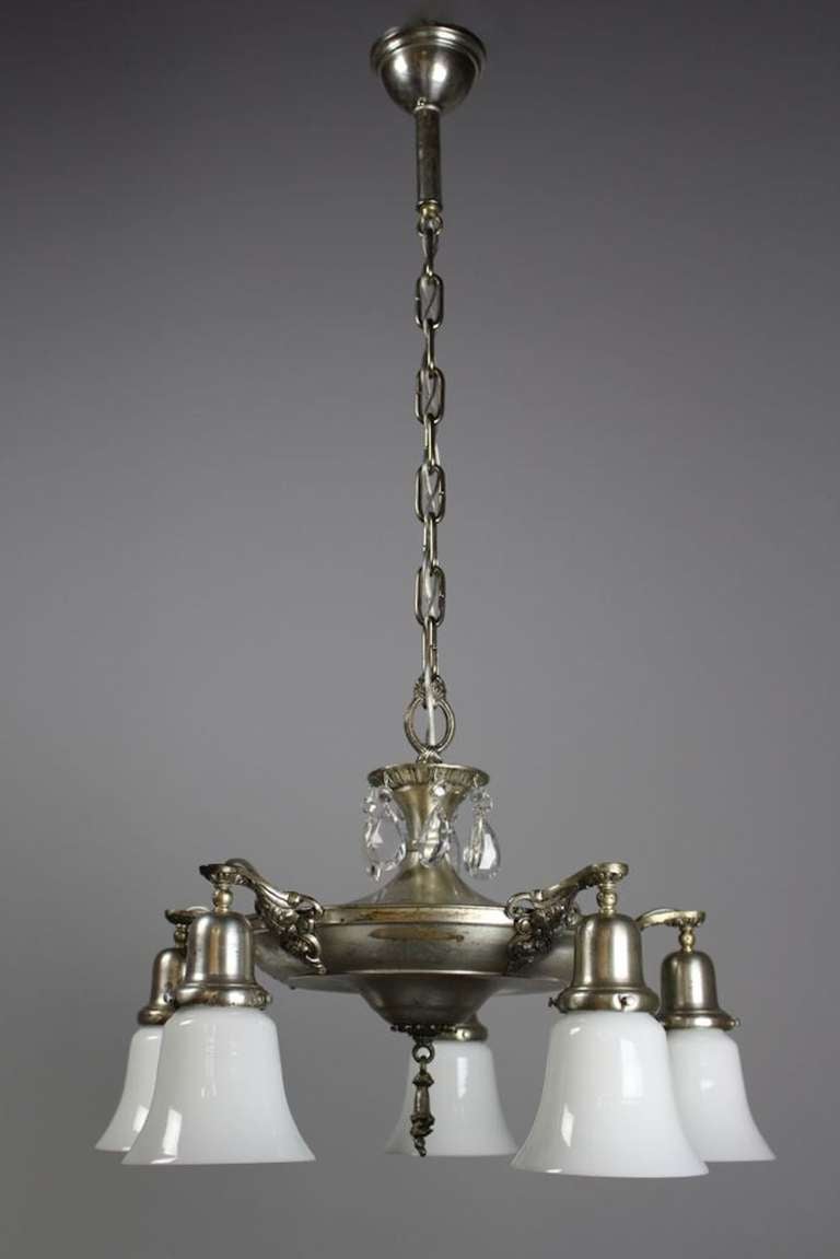 Circa 1925, this five light chandelier has been restored to its original silver plate finish, rewired, restored and fitted with milk glass shades. Found in Boston.
SKU: DF1173 Measurements: 39