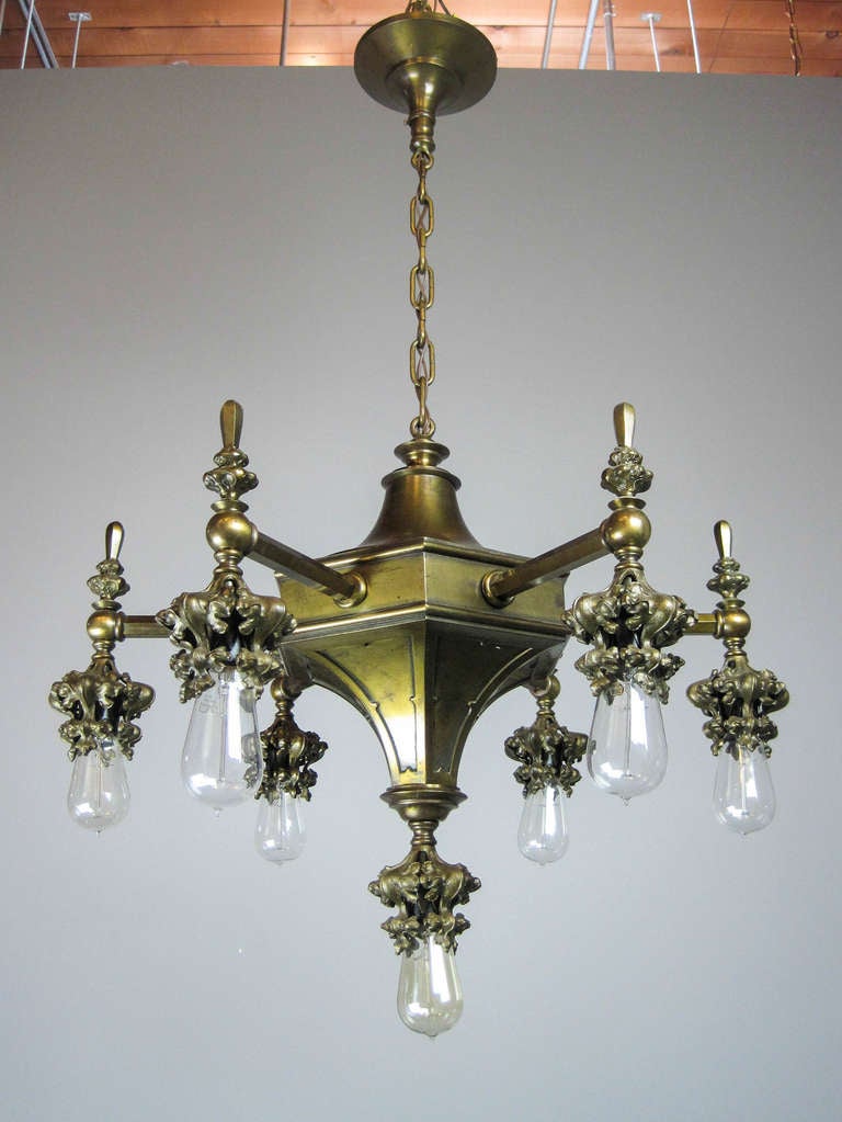 All original finish, 7-light Gothic Arts & Crafts bare bulb chandelier. Attributed to Cassidy of New York City. Fitted with Tungsten bulbs. 43