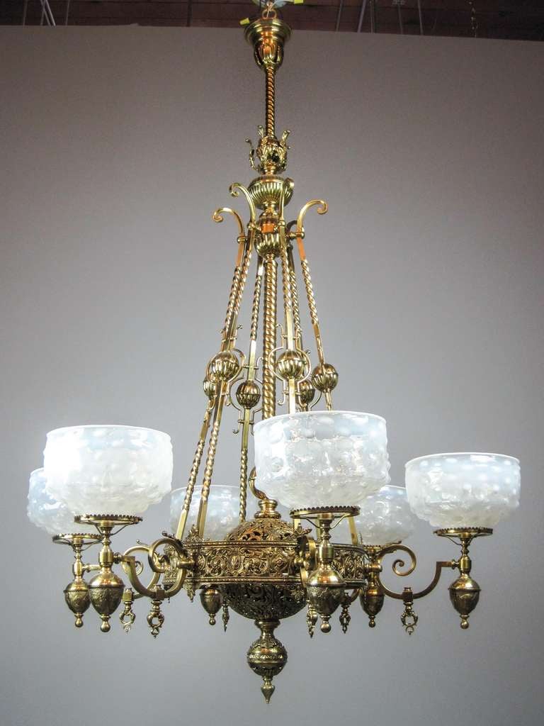 Ca. 1885 An outstanding ‘Romanesque’ style six-light converted chandelier from the golden era of early American gas lighting.
Wrought out of hand-hammered over-form brass and twisted square rods; fitted with period-correct ‘Hobb-Nail’ antique
