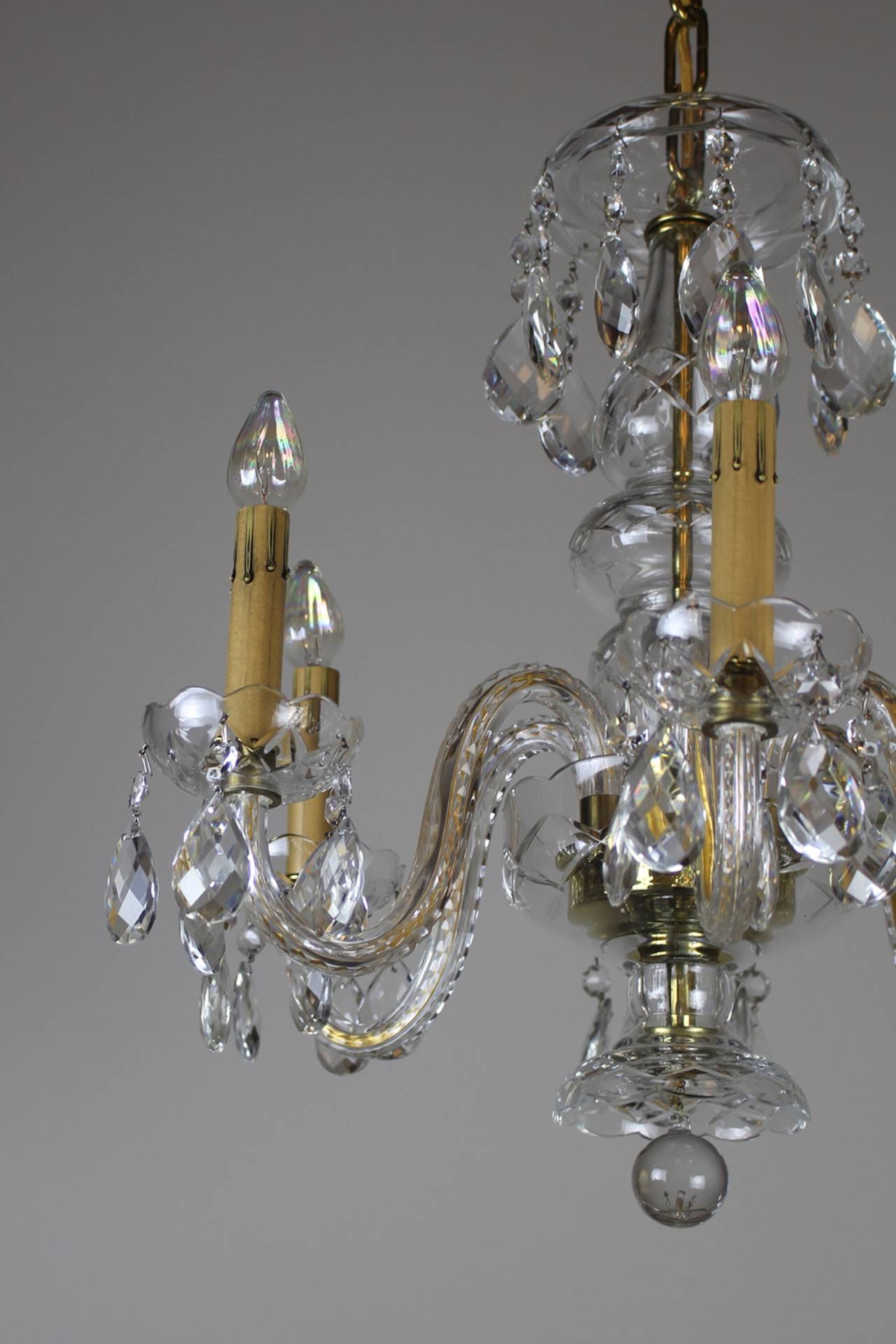 A lovely Italian made cut-crystal chandelier on the petite side, circa 1950s. Though not terribly large, this light has great presence and is lovely quality. 

Made in the 1950s, in the Louis XVI style this fixture boasts a cut crystal body with