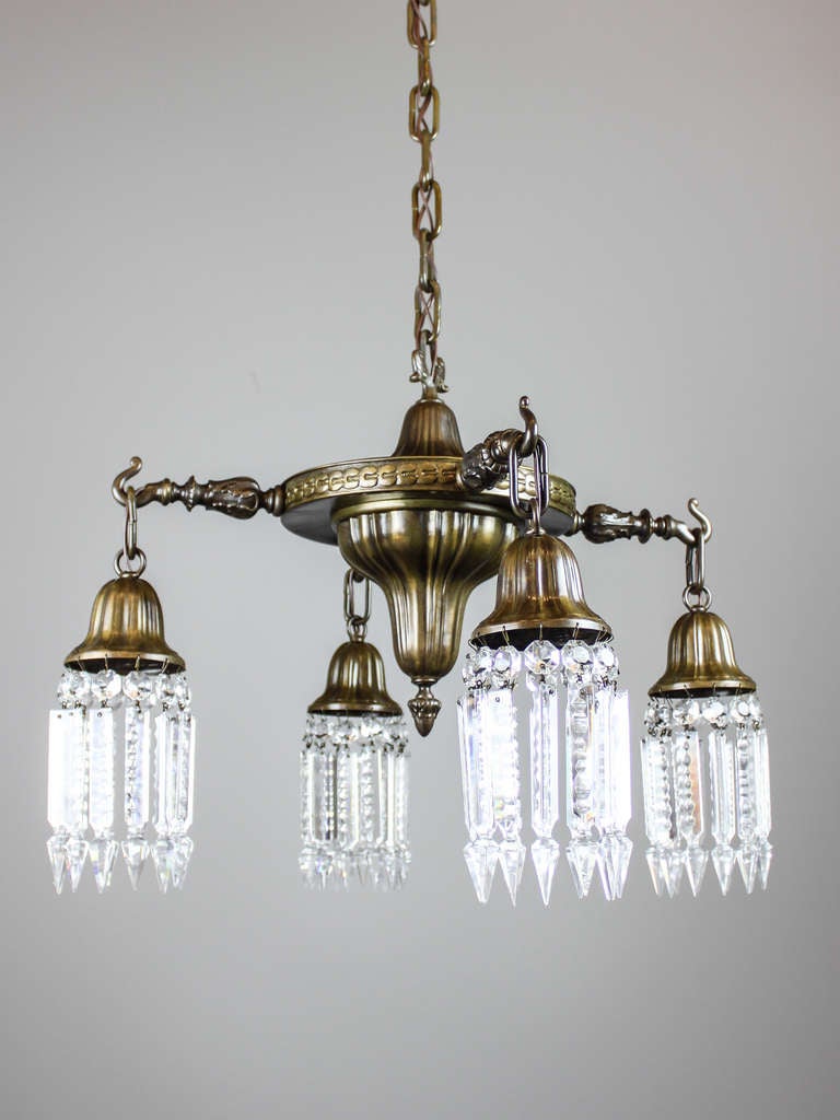 Unusual American light fixture with Sheffield pattern and original high-low finish, circa 1918. The rim is embossed with circular geometric pattern and all four arms are heavy cast with acanthus leaf and finished all around. Hooked bell sockets are
