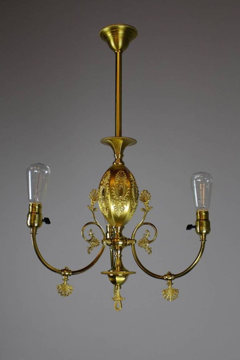 Circa 1900. This lovely and decorative converted gas fixture shows a restored matte and gold finish. A piece of quality made by R. Williamson & Co. of Chicago. All original parts, electrified early on, shown with Edison bulbs.
SKU: DF1193