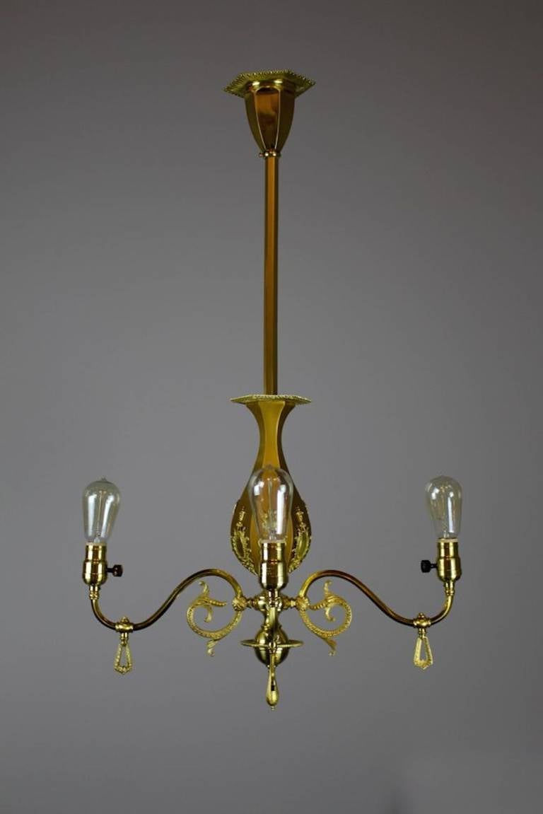 Ca. 1905. A very charming Victorian style light fixture featuring decorative castings. A high quality piece by R. Williamson & Company of Chicago restored to its matte and gold finish. Completely restored and rewired. Originally a gas fixture,