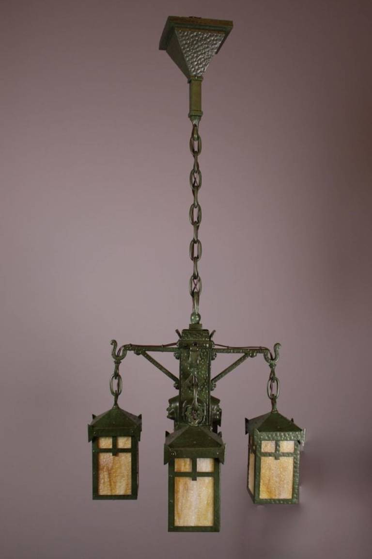 Ca. 1906 Arts & Crafts four-light ‘Monk’ fixture attributed to ‘Bradley & Hubbard.’ Predominantly hand made with hammered bronze body and lantern shades. An unusual design embodied in the original ‘Verdigris’ finish and fitted with period correct