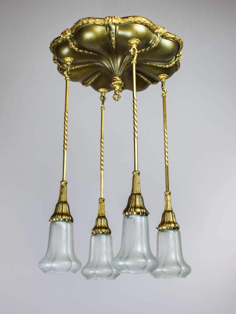 Ca. 1915 Antique flush mount light fixture with original patina and gilt bronze castings. An exceptional example of it's category, this flush mount is completely intact can decorated with heavy cast gilt bronze foliate, twisted rod arms and bell