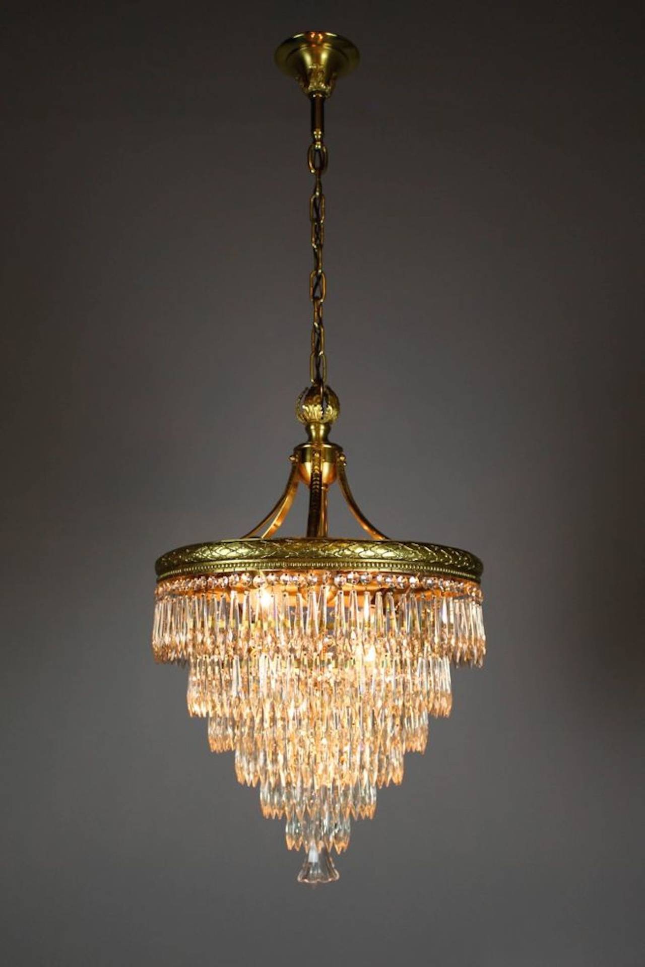 This is an absolutely stunning light, attributed to E. Miller & Company, circa 1910. This seven-tiered crystal chandelier is in what is referred to as 