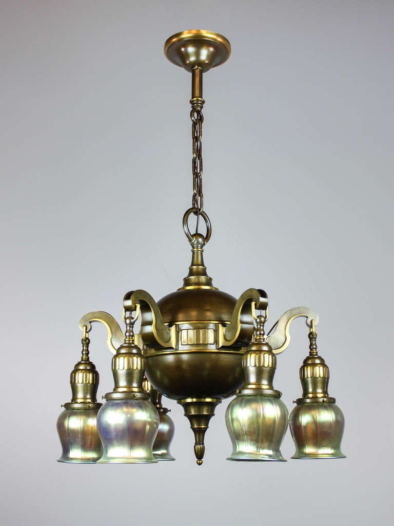 Highly unusual antique ball light fixture in the Edwardian style, fitted with art glass shades, circa 1915. A substantial fixture, decorated with minimalistic vertical relief pattern on middle band and bell holders. Finished in a deep bronze, fully